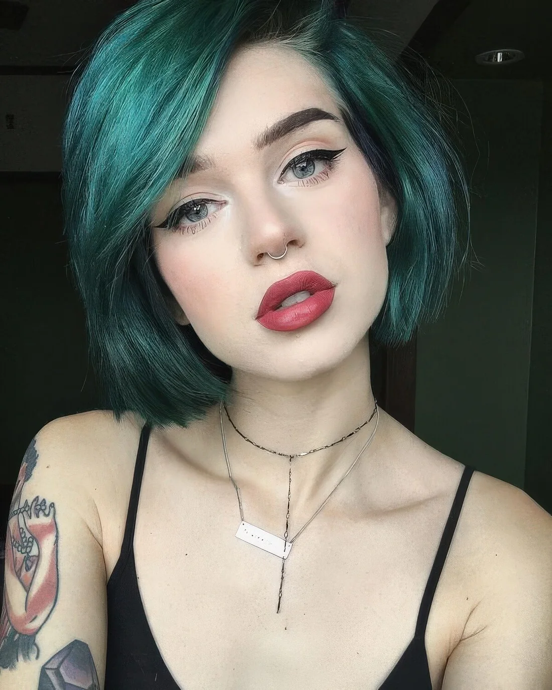 Photo showing green liquid bob with side part, with the hairstyle clearly visible.