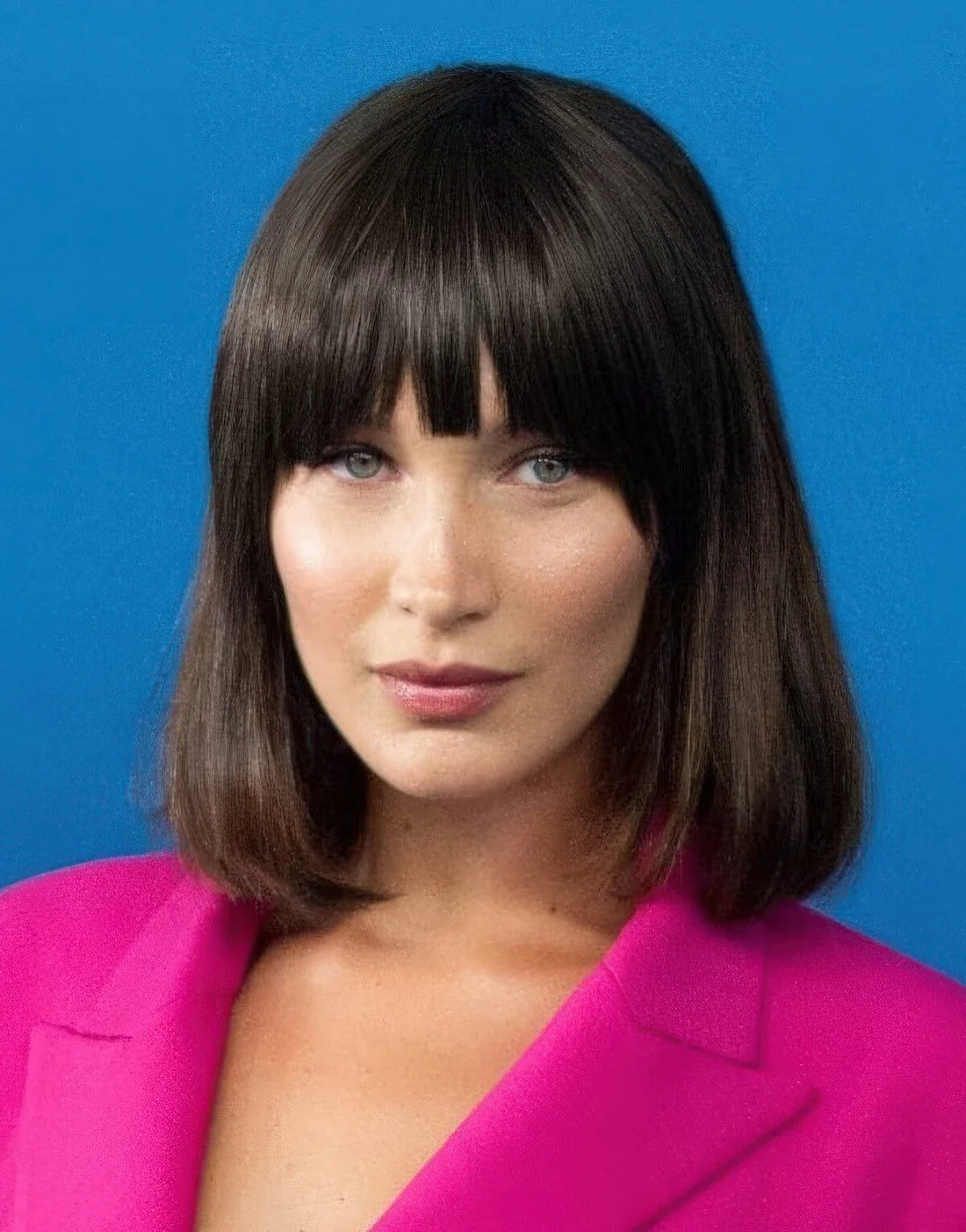 Bella Hadid wearing a dark brown liqud bob with bangs inspired by an iconic hairstyle of Michelle Pfeiffer.