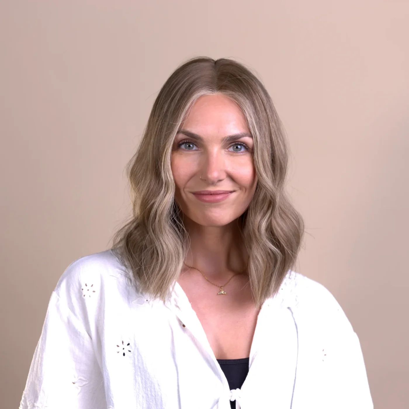 shoulder wavy chestnut lob shown as a lob haircuts for thin hair idea, featuring chestnut color, shown in soft taupe wavy lob
