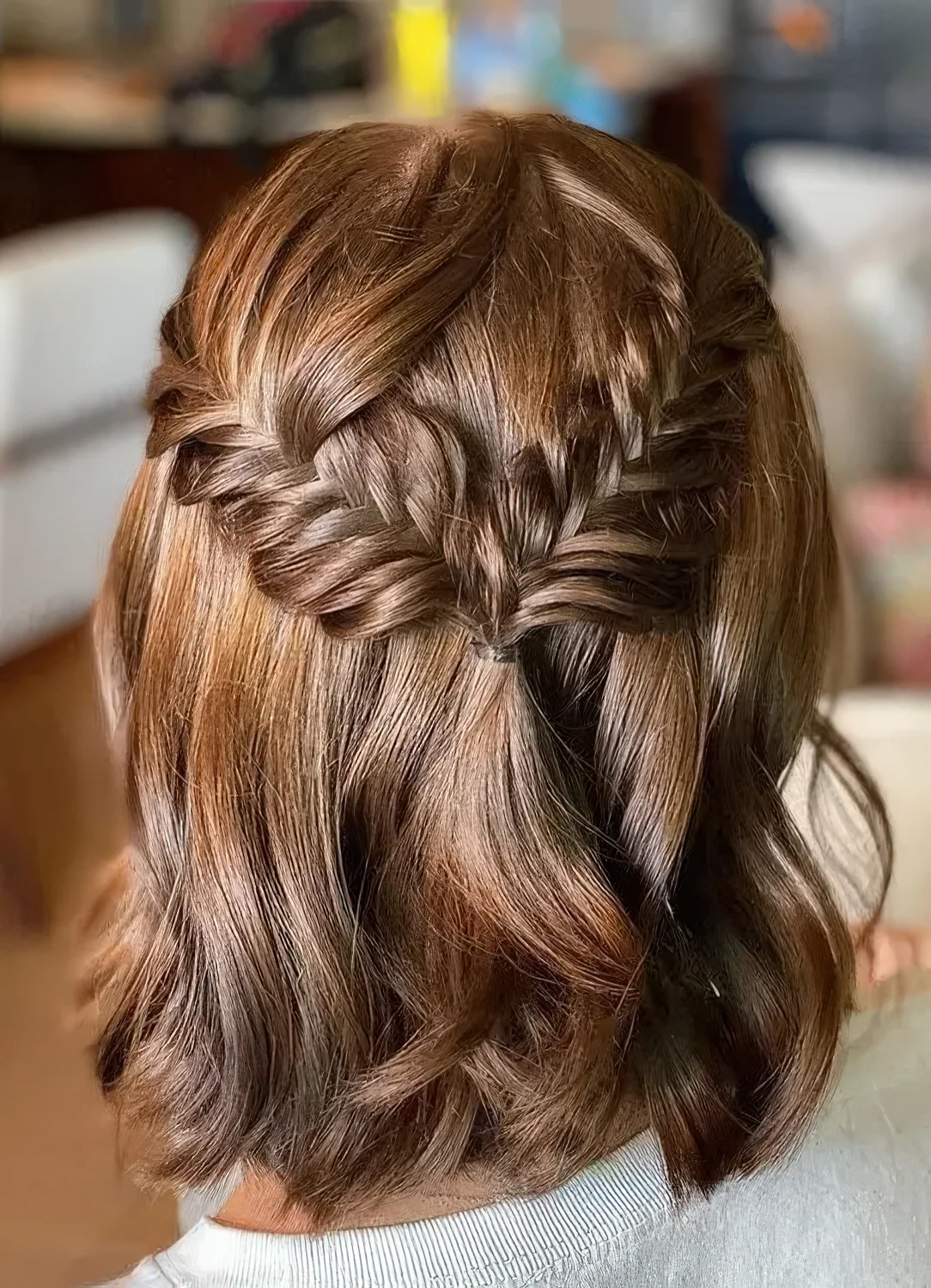 Medium half updo with a fishtail braid halo and waves down.