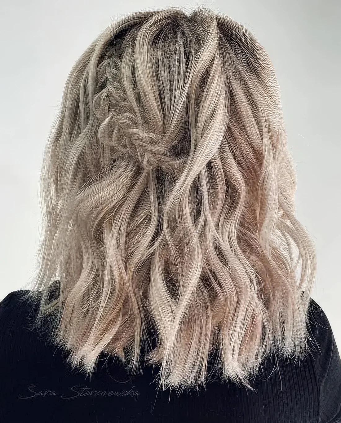Boho half updo with a waves, a braided element and a lot of volume.
