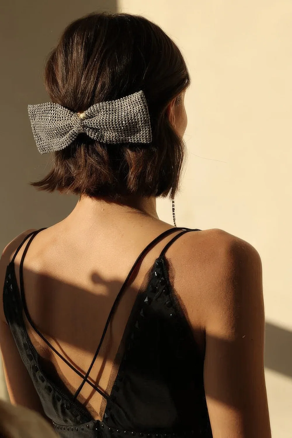 Classic half updo with some volume and texture plus a huge embellished bow as a trendy and bold accent.