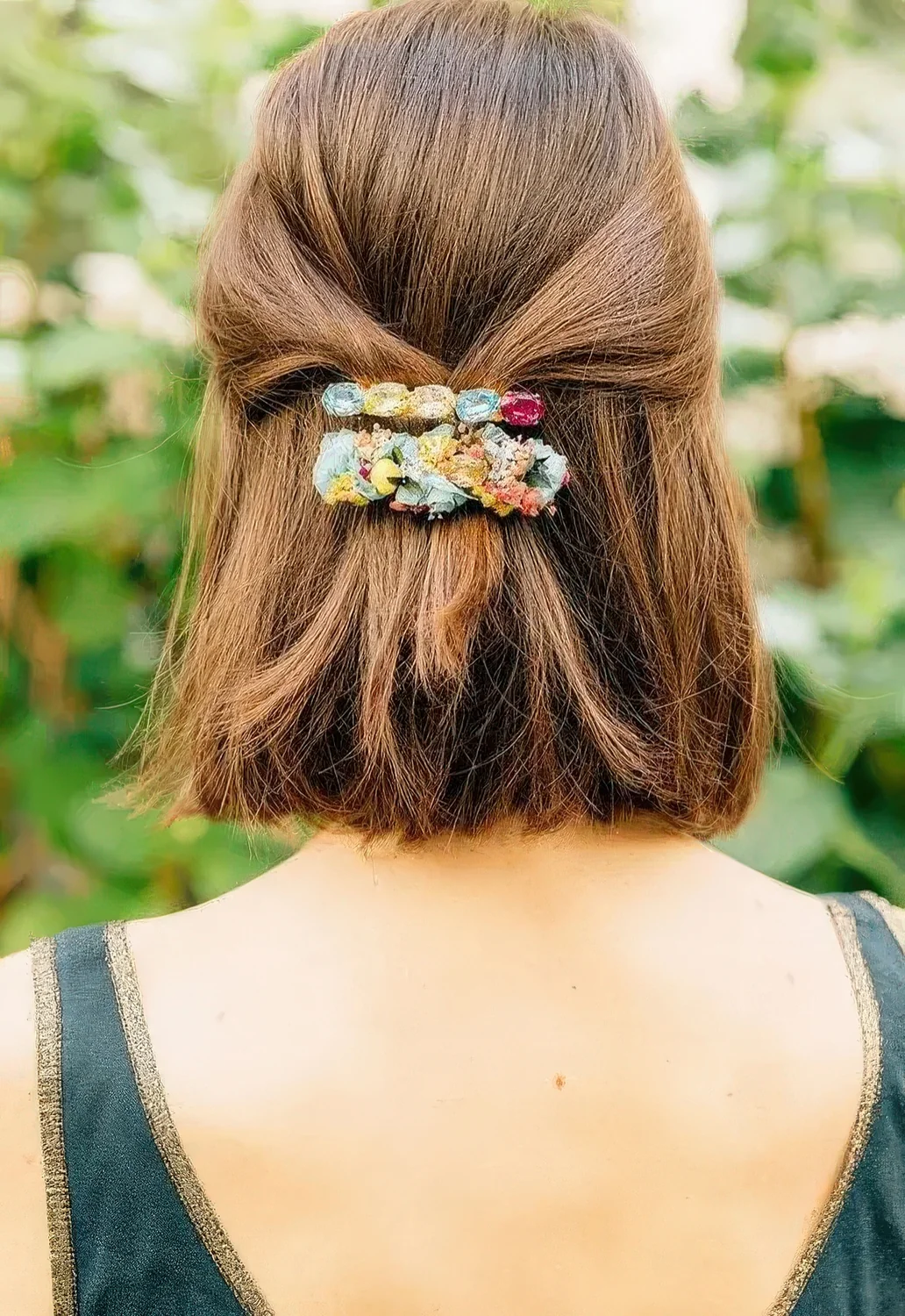 Half updo with straight volumetric hair and colorful barrettes.