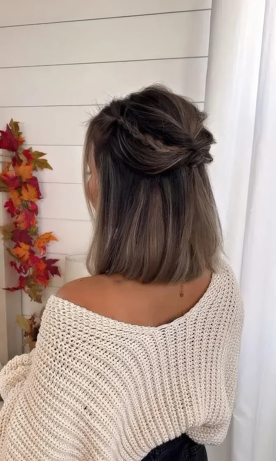 Medium hair half updo with a bump, twists and braids and straight hair down.