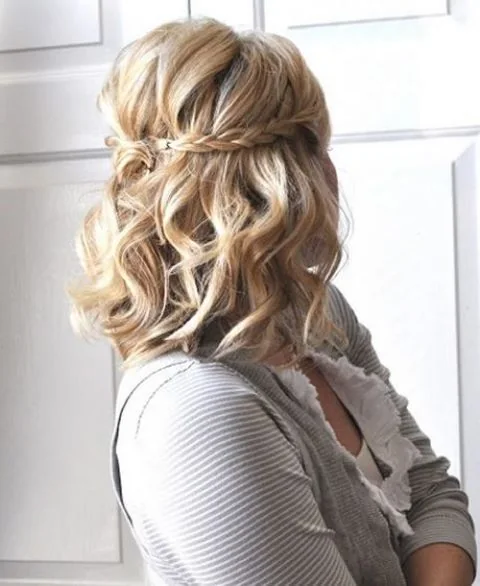 Photo showing wavy half updo with a braid, with the hairstyle clearly visible.