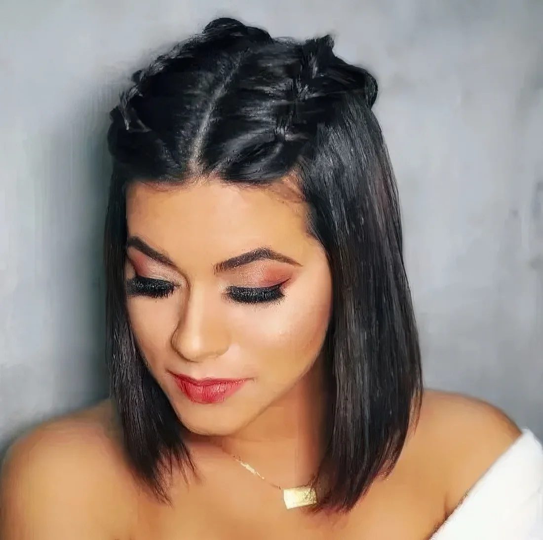 Long black bob with straight hair and two braids on top.