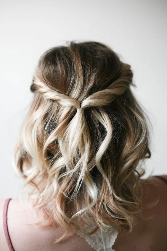 Photo showing twisted wavy half updo, with the hairstyle clearly visible.