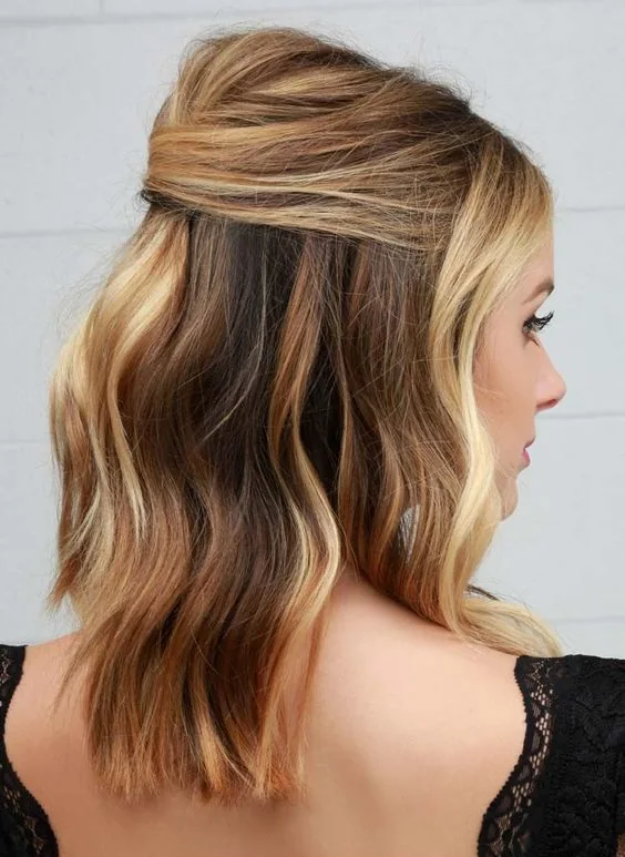 Photo showing wavy half-up lob, with the hairstyle clearly visible.