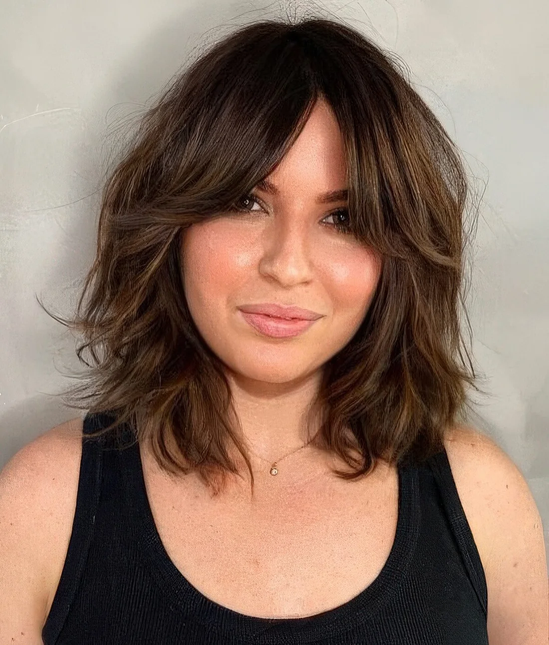 Bob hairstyle with bottleneck bangs.