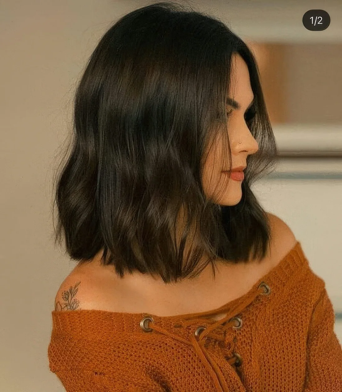 Photo showing black wavy long bob, with the hairstyle clearly visible.