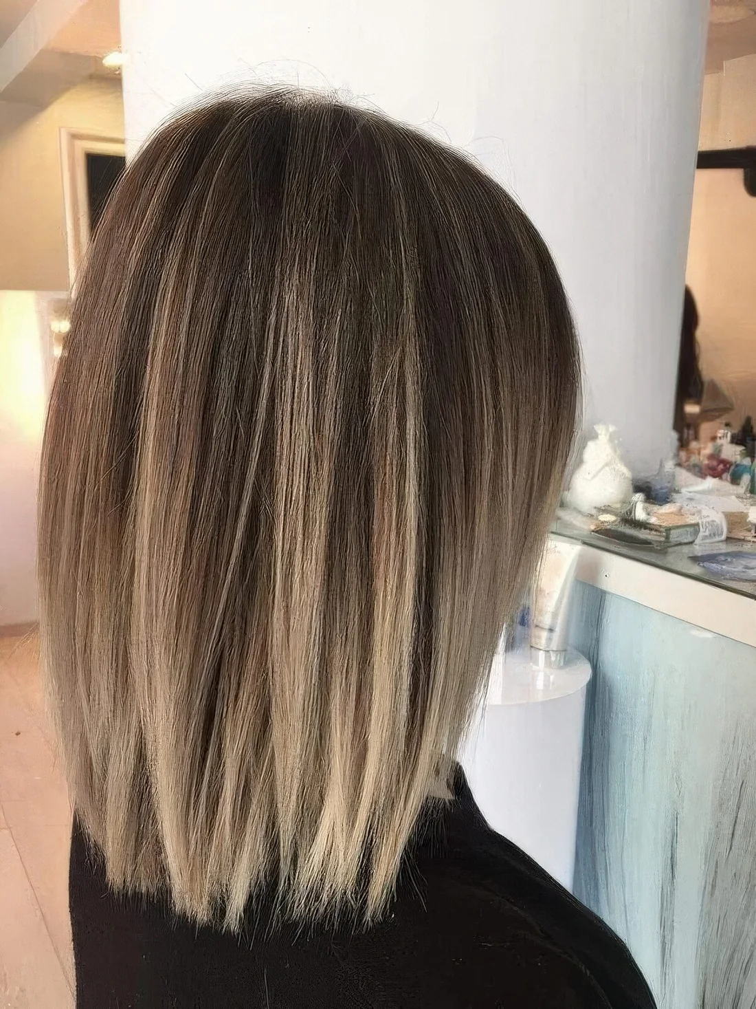 Brunette long bob with blonde highlights all over.