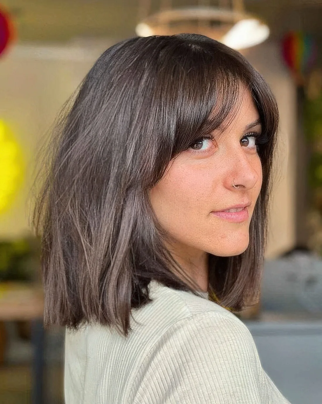 Dark brunette long bob with bottleneck bangs paired with curtain ones.