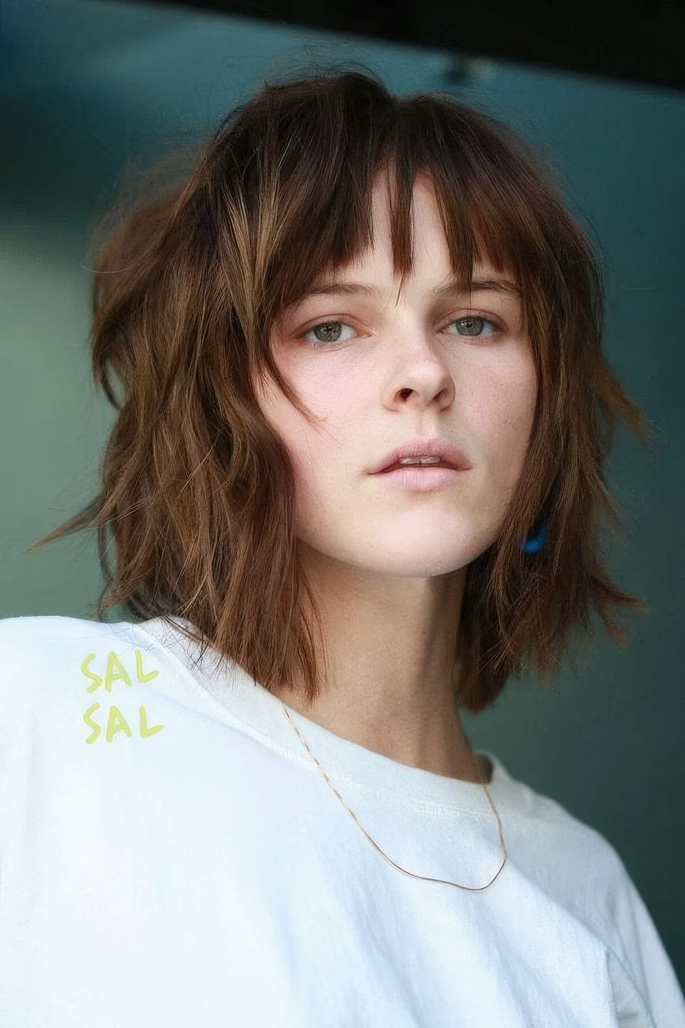 Shaggy long bob with bottleneck bangs and messy waves.