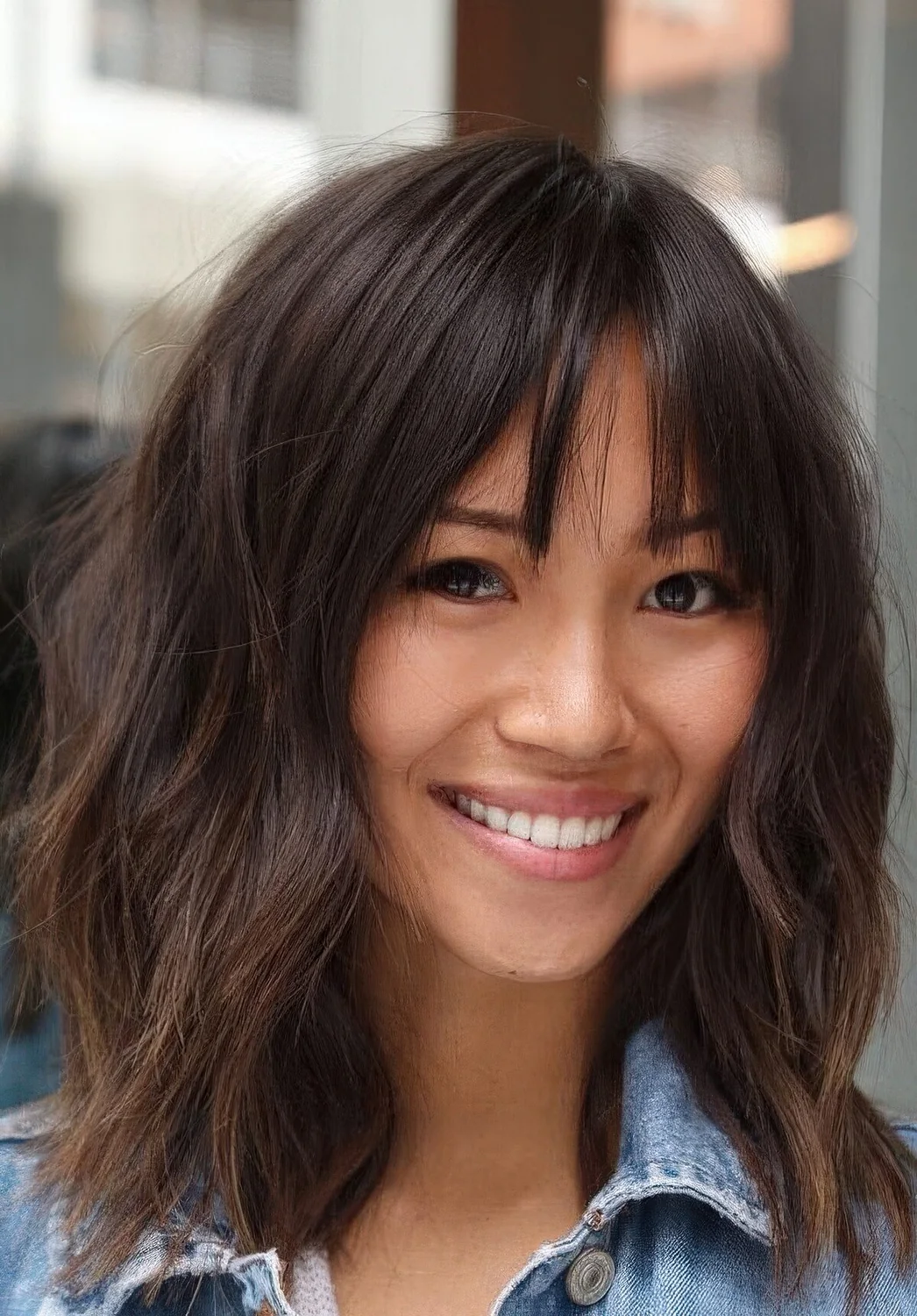 Layered lob with bottleneck bangs and a rich brown tone.