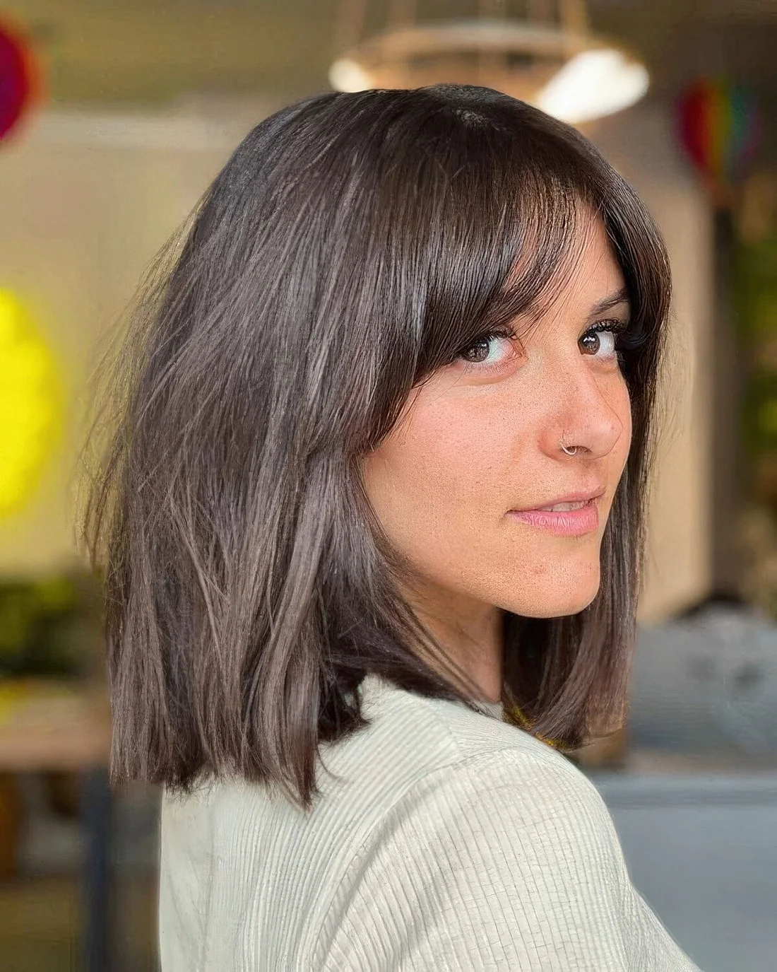 Dark brunette long bob with bottleneck bangs paired with curtain ones.