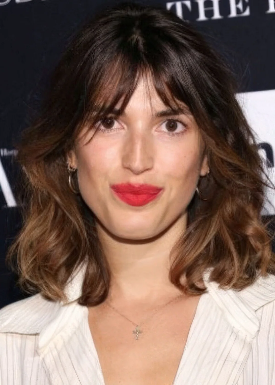 Medium-length brunette hair with an ombre effect and bottleneck bangs.