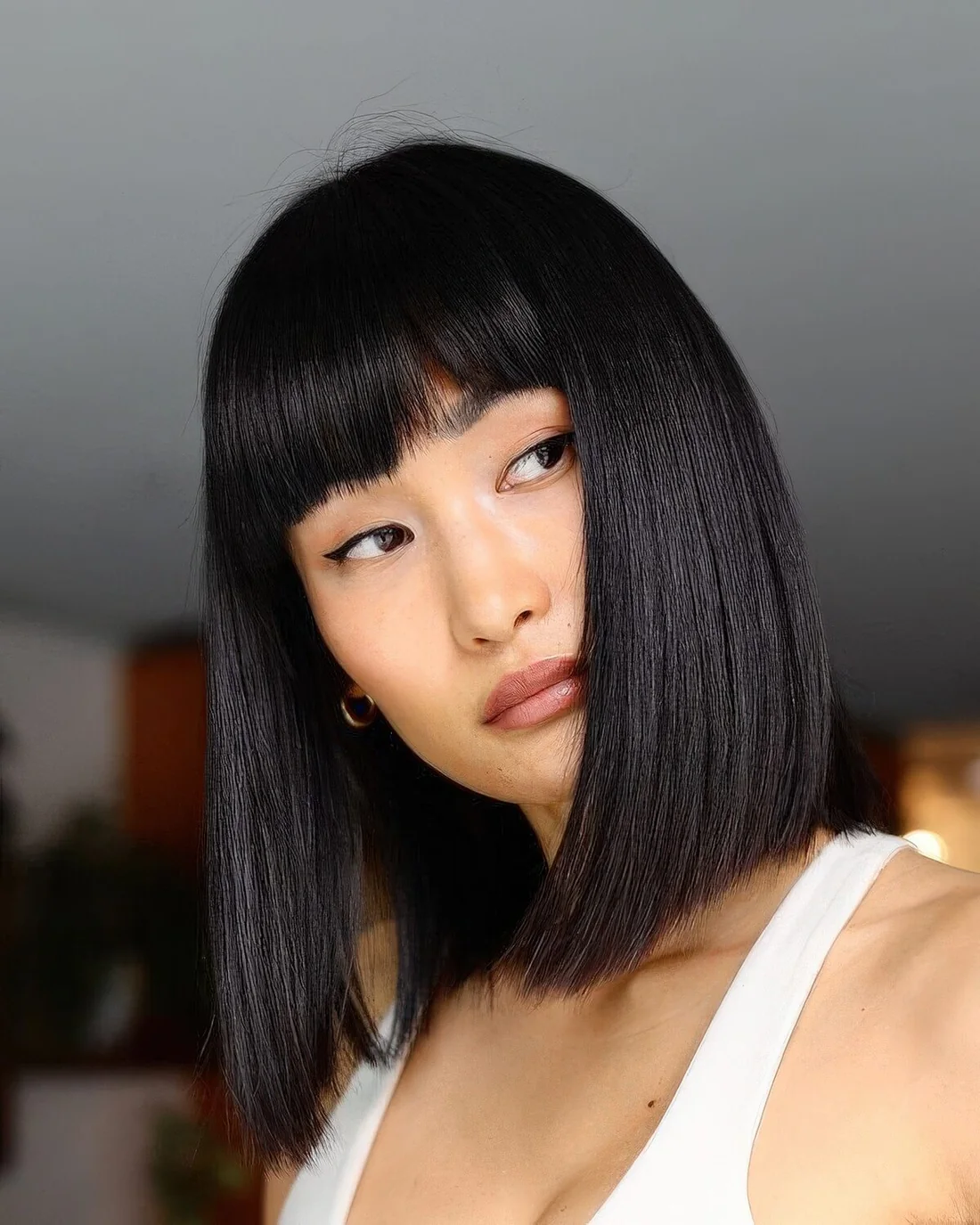 Photo showing black sleek bob, with the hairstyle clearly visible.