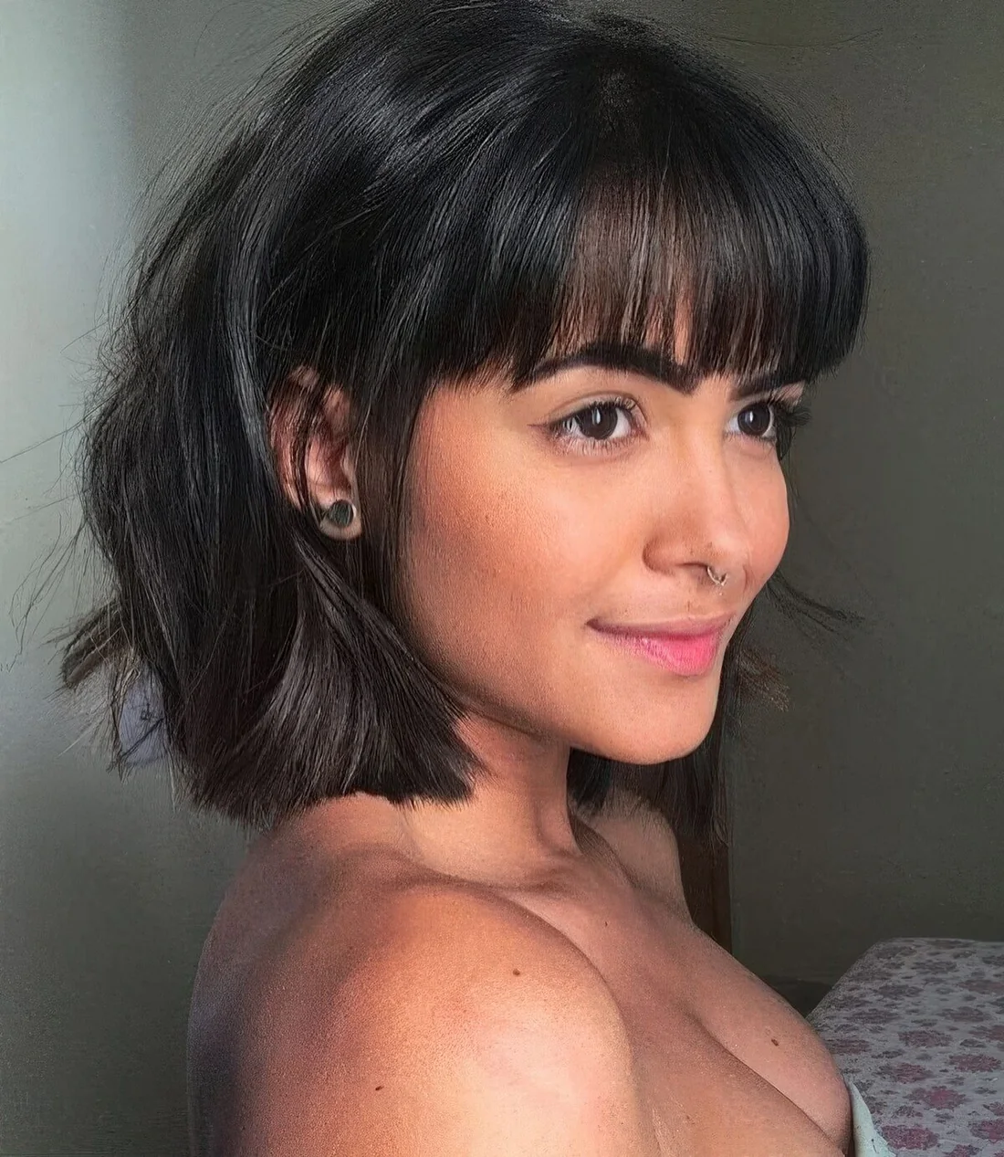 Photo showing black wavy bob, with the hairstyle clearly visible.