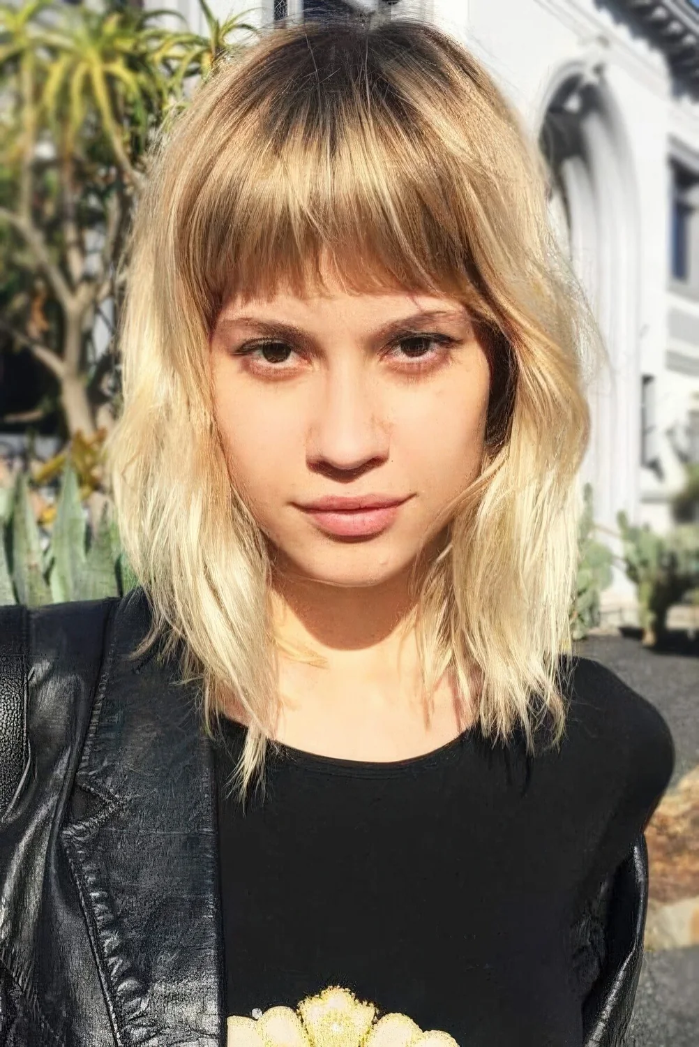 Photo showing blonde textured bob, with the hairstyle clearly visible.
