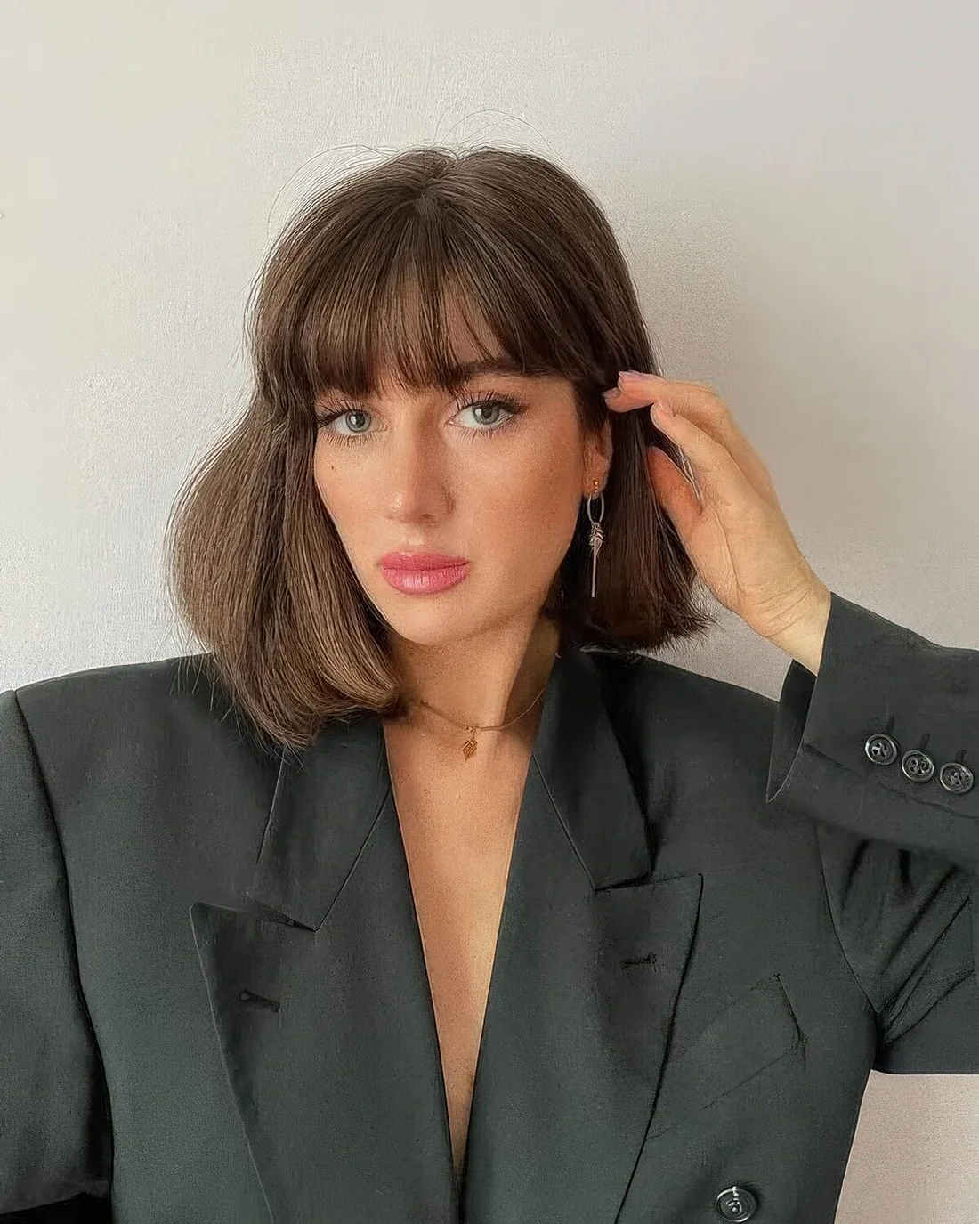 Photo showing long brown bob fringe, with the hairstyle clearly visible.