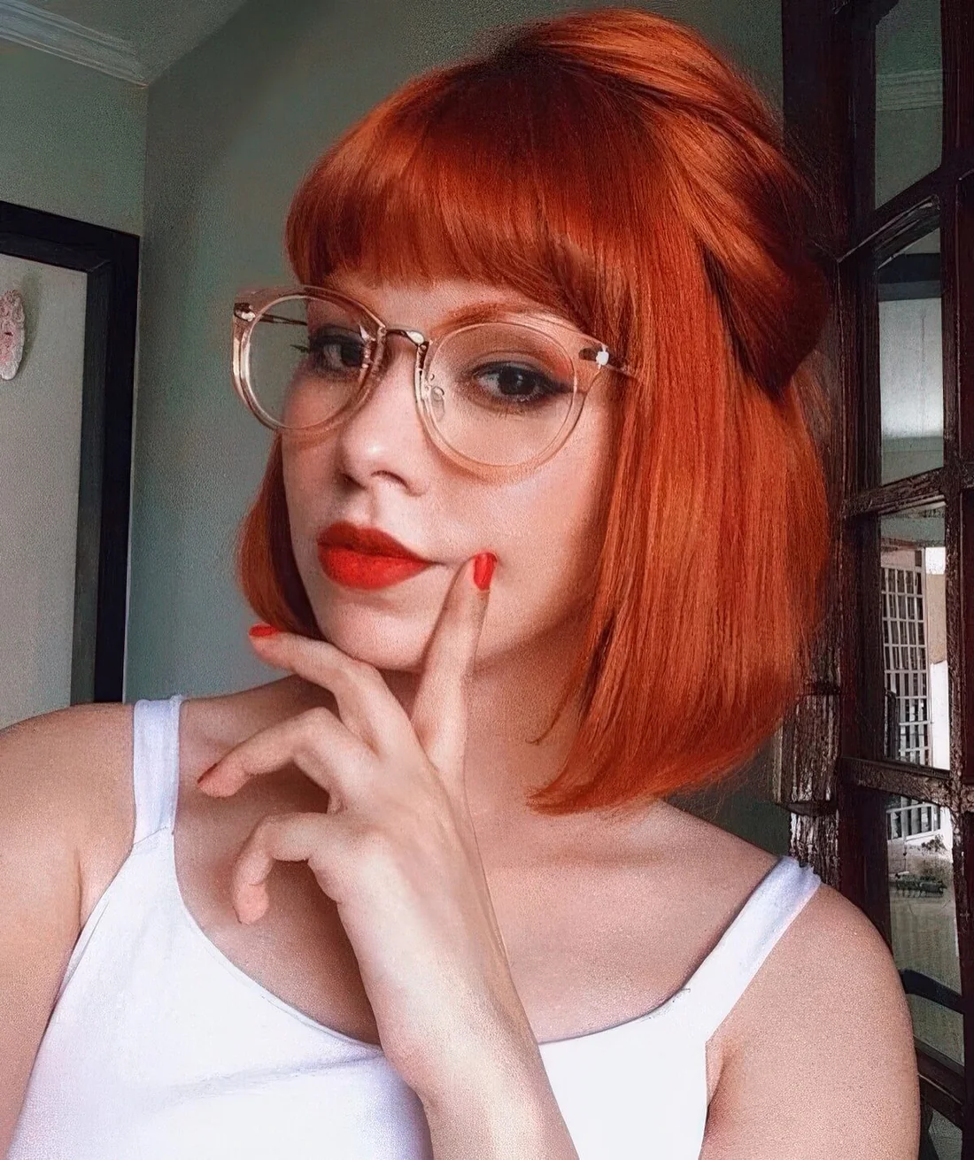 Photo showing orange red bob, with the hairstyle clearly visible.
