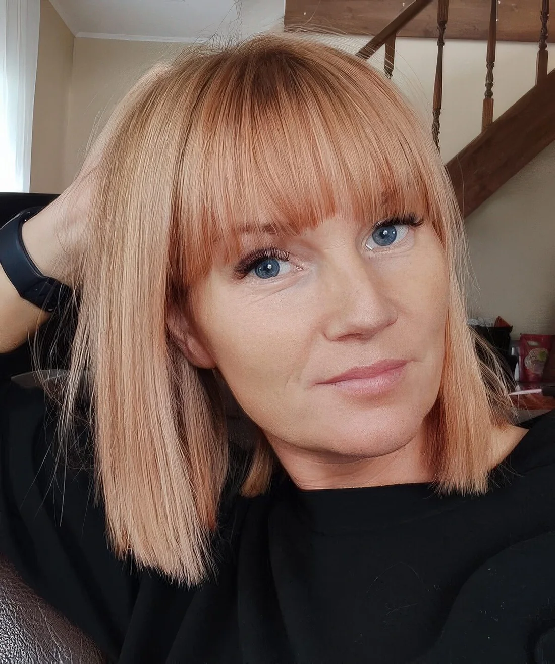 Photo showing peachy long bob, with the hairstyle clearly visible.