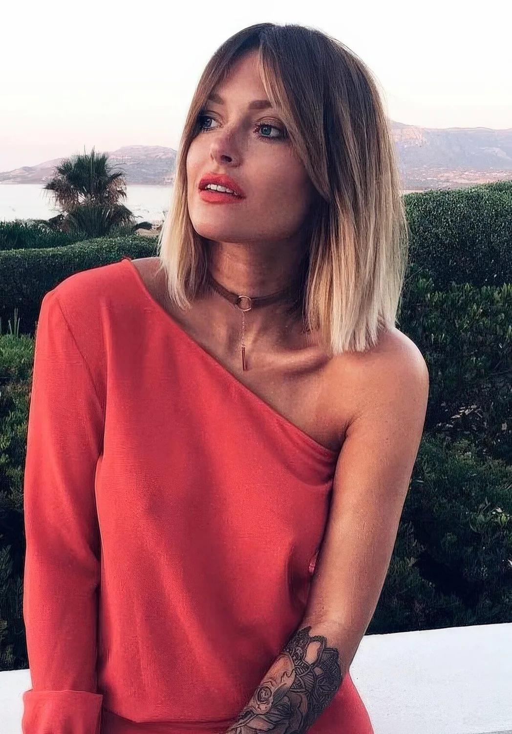 Ombre brown to icy blonde shoulder-length bob with short curtain bangs.