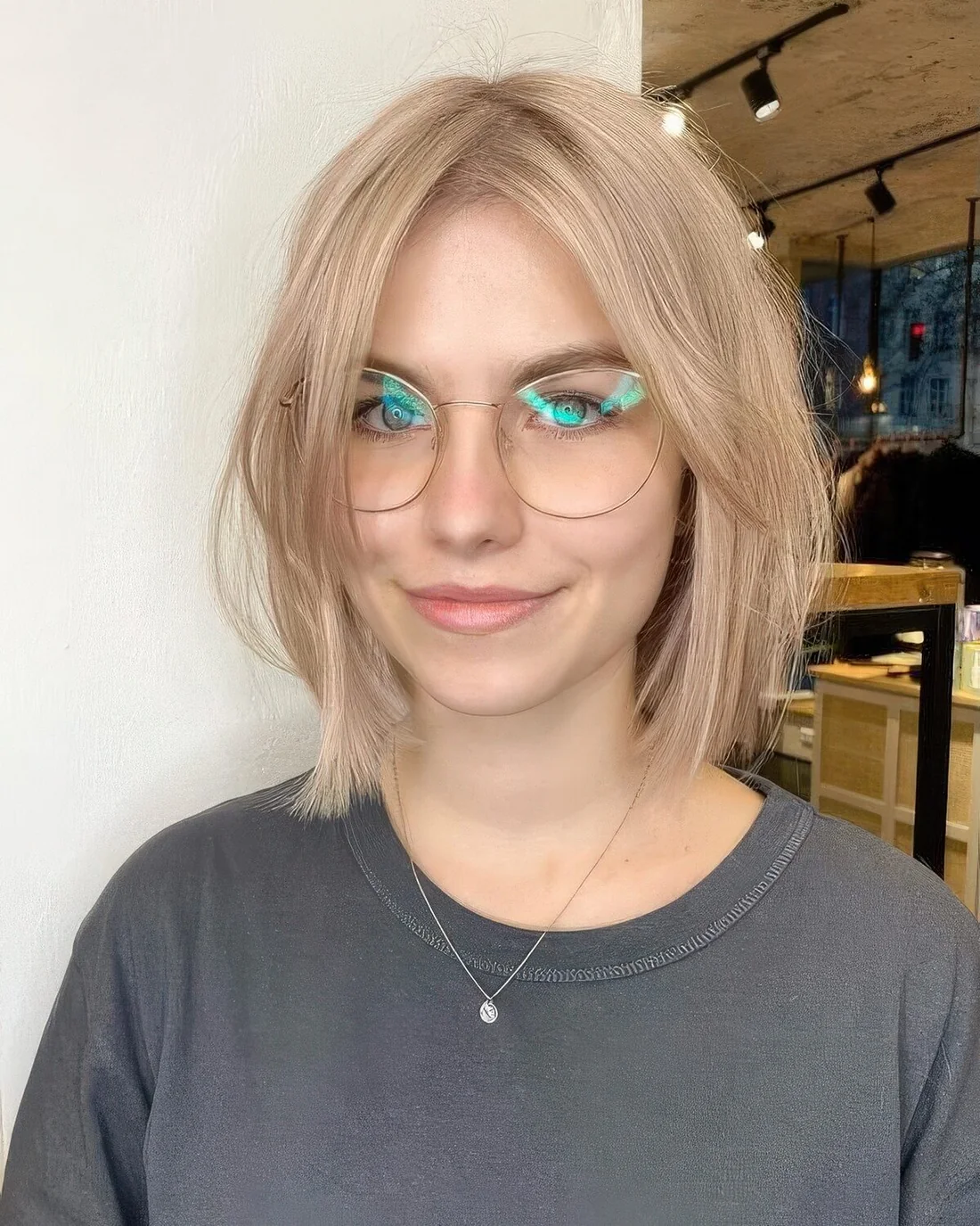 Colb blonde long bob with curtain bangs.