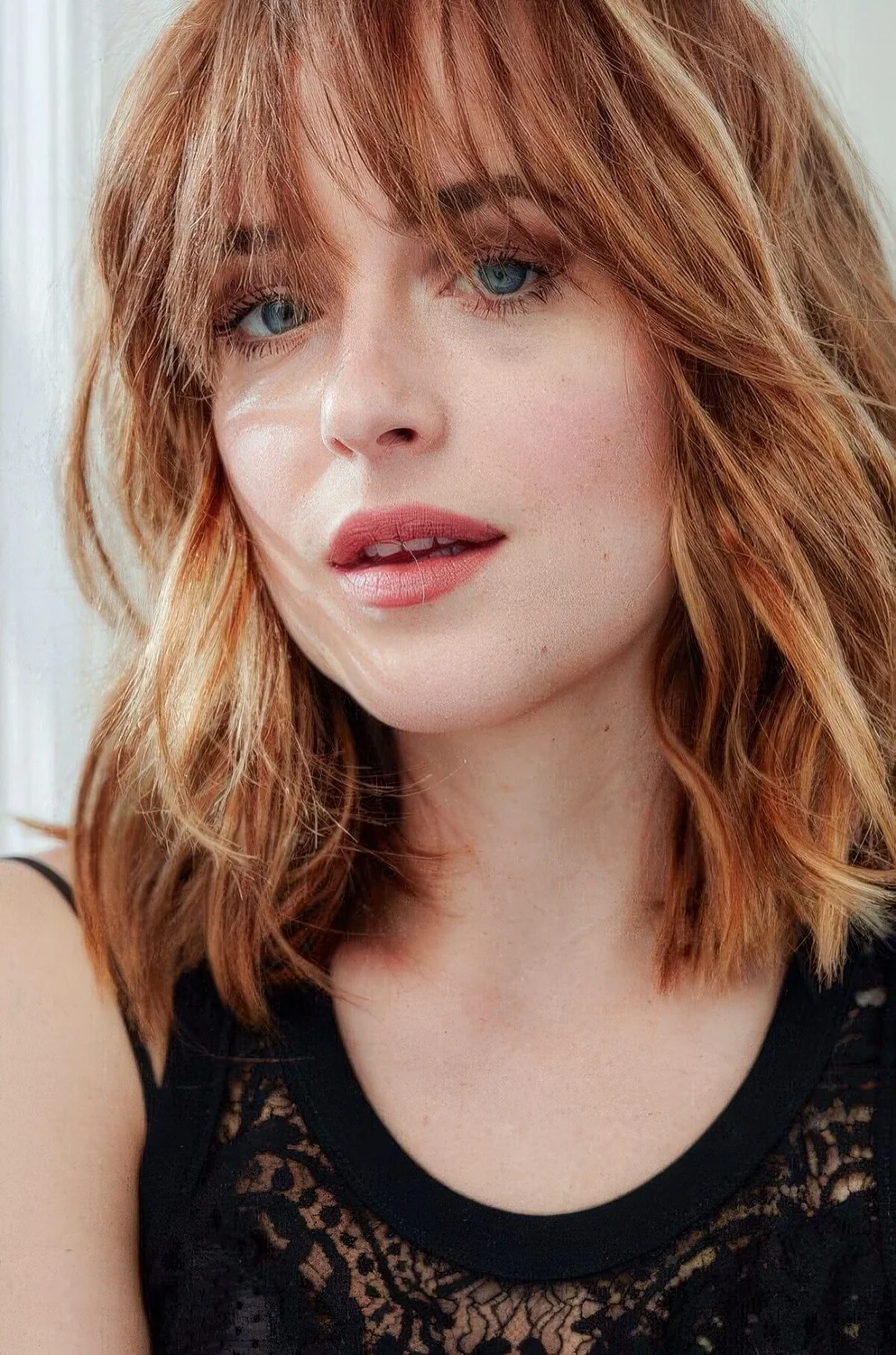 Ginge outgrown textured bob with blonde highlights and outgrown wispy bangs.
