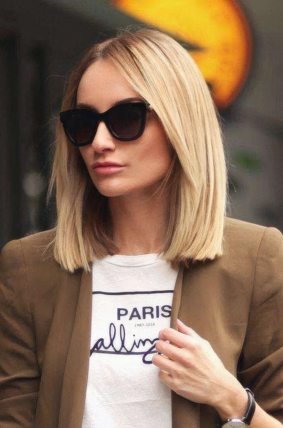 Classic blonde clavicut with sleek and voluminous hair and curtain bangs.