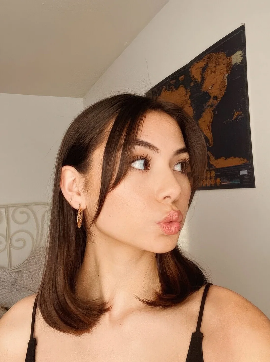 Medium-length dark hair with curtain bangs.