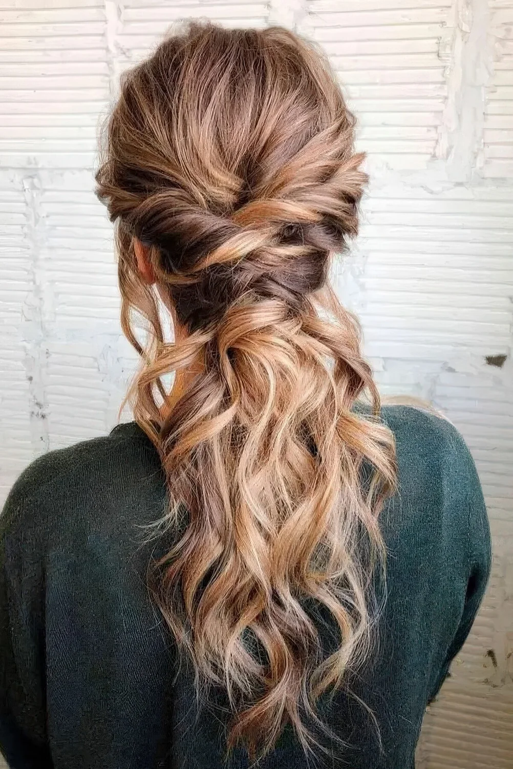 Low ponytail with twists and a wavy top.