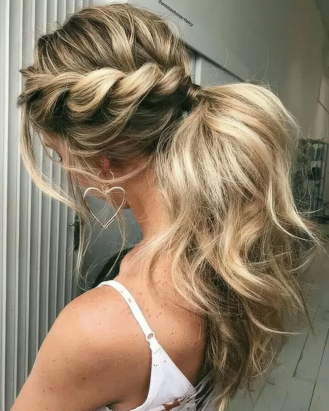 Low ponytail with two twisted braids on the sides and locks down for a simple modern look.