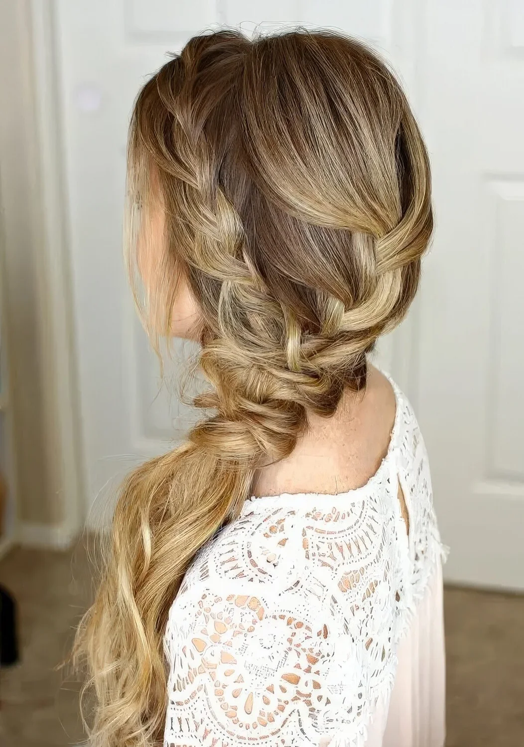Low braided ponytail made up of several braids plus a halo.