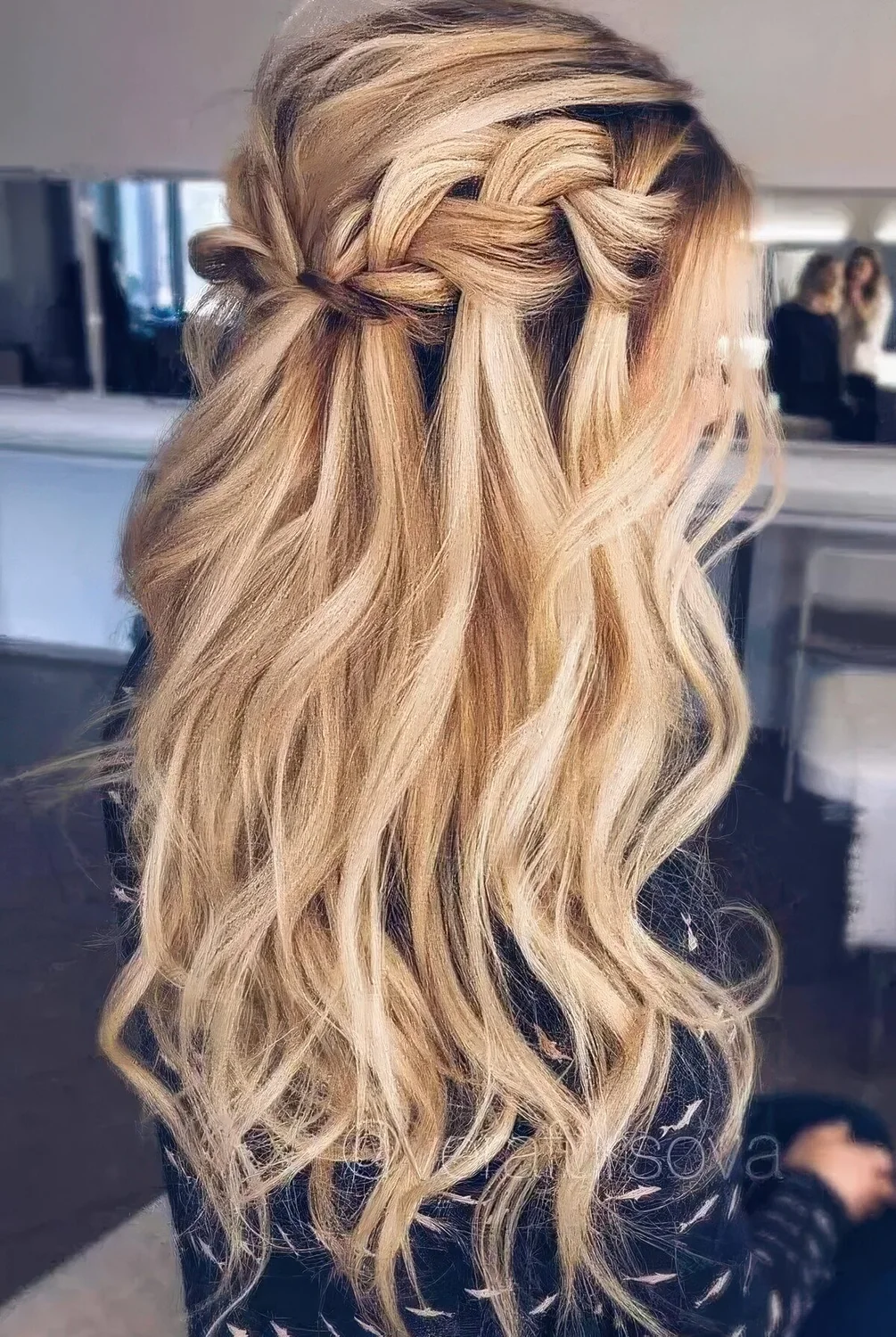 Long wavy half updo hairstyle with a braided halo and locks down for a boho feel.