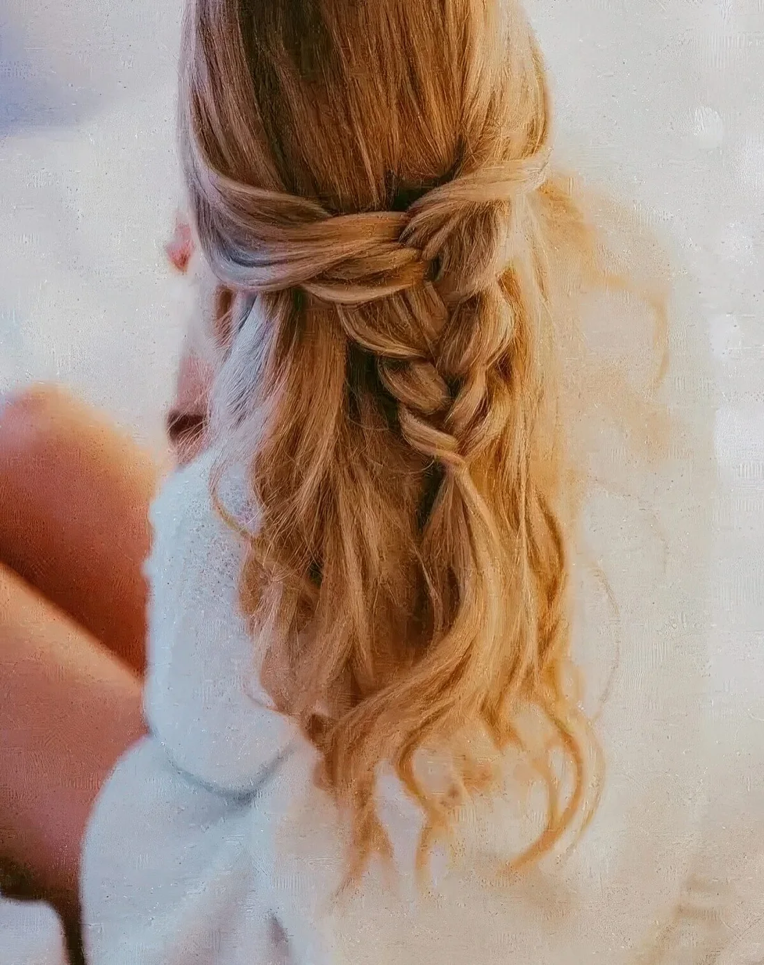 Half updo with a loose braid and waves down.