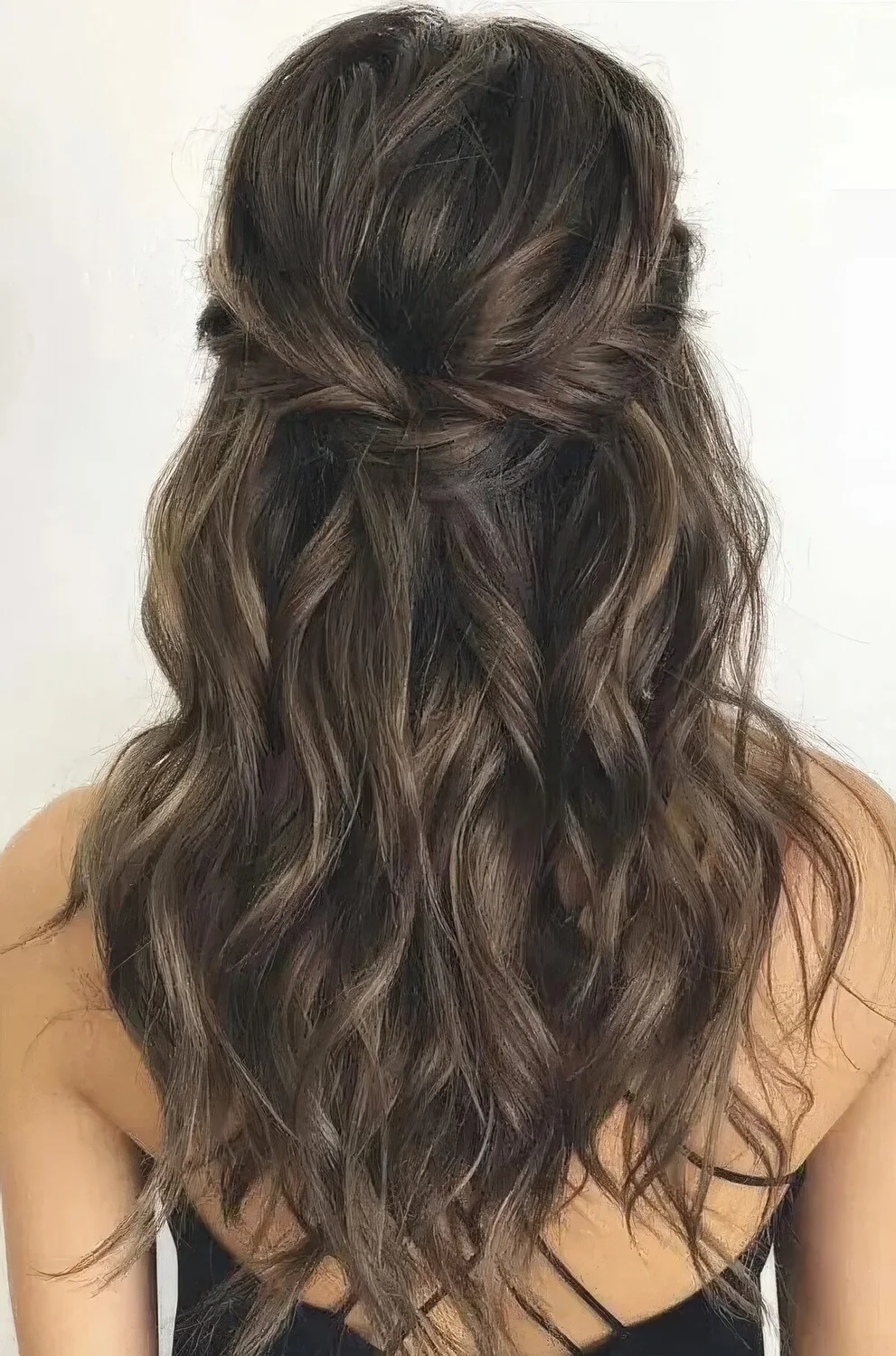 Long half updo with a braided halo and waves down.