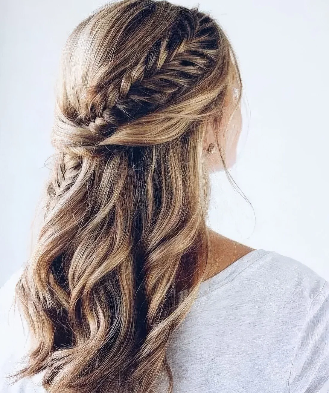 Chic half updo with waves, twists and a fishtail braid going down for a boho bridesmaid.