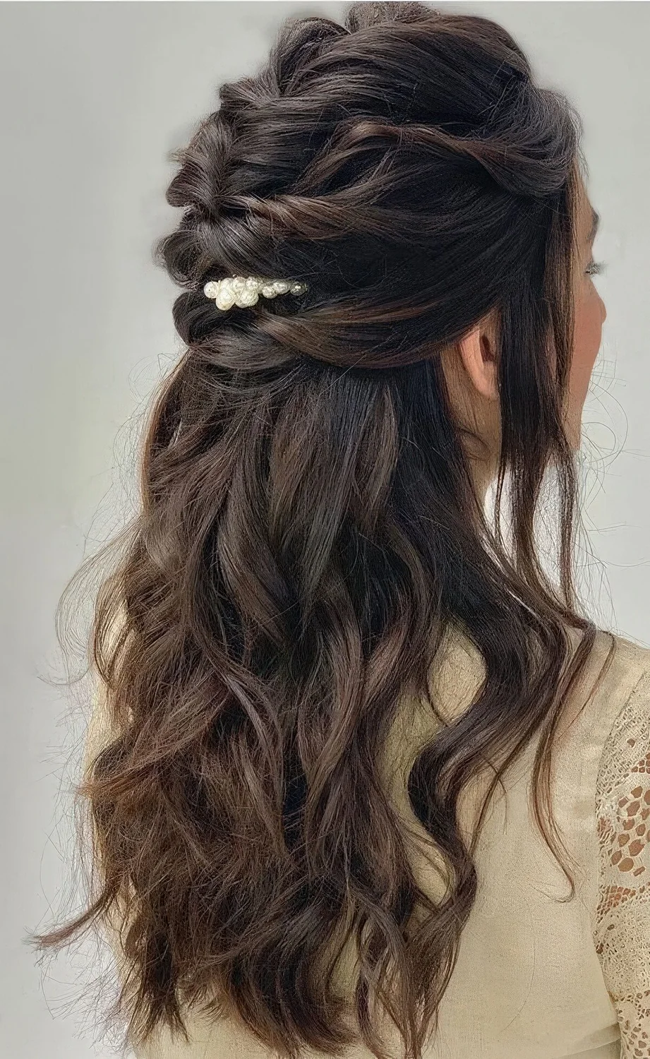 Long hair half updo with a braided top, waves down and a pretty pearly hair pin.