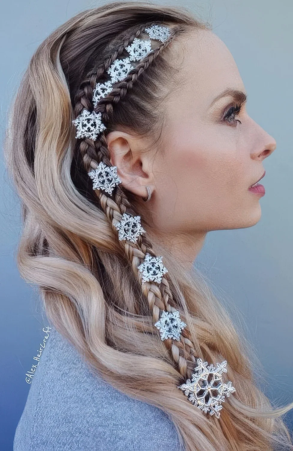Unique half updo with two side braids and little snowflakes plus waves down.