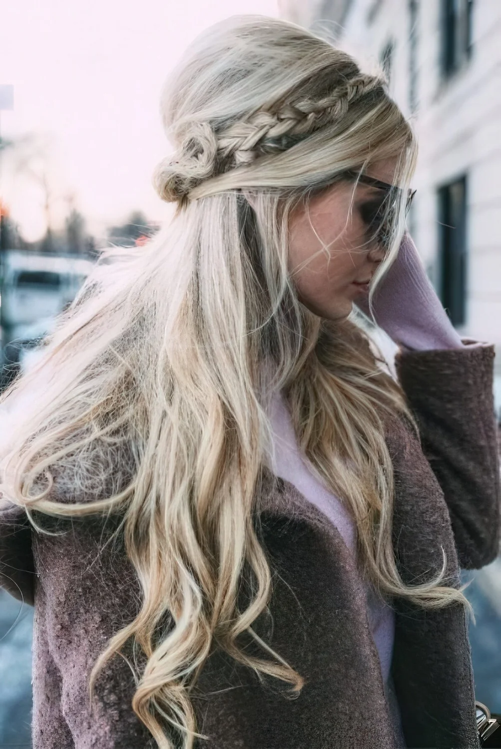Long wavy half updo with a braided halo, a bump and much texture for holidays.
