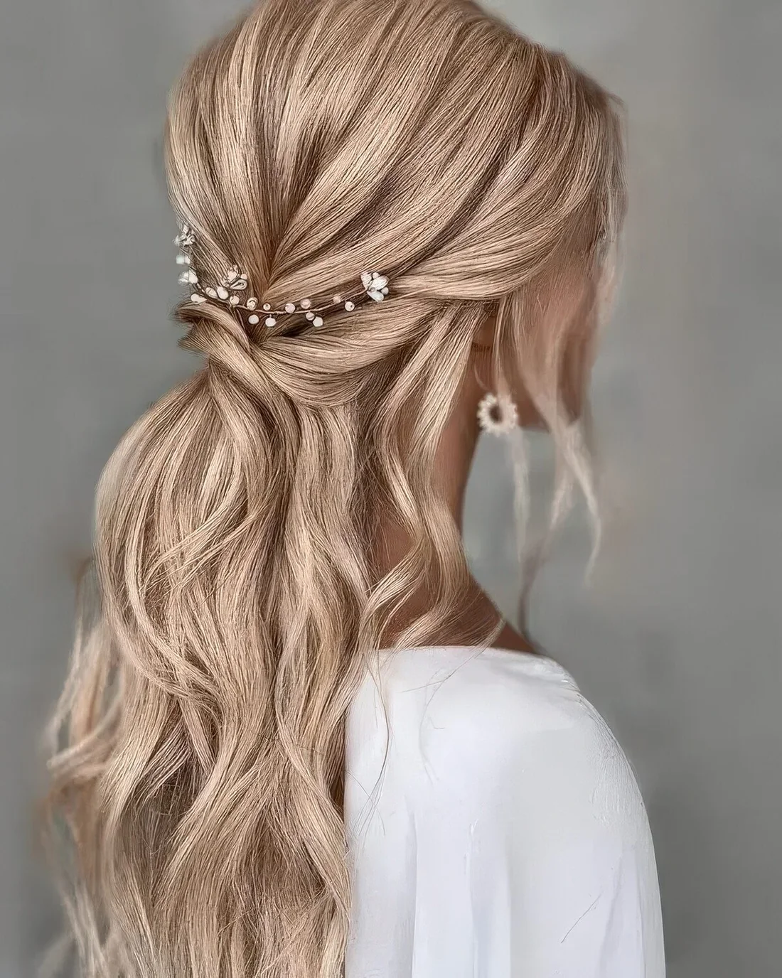 Half updo with a bump on top, some twists and waves down plus some face-framing locks.