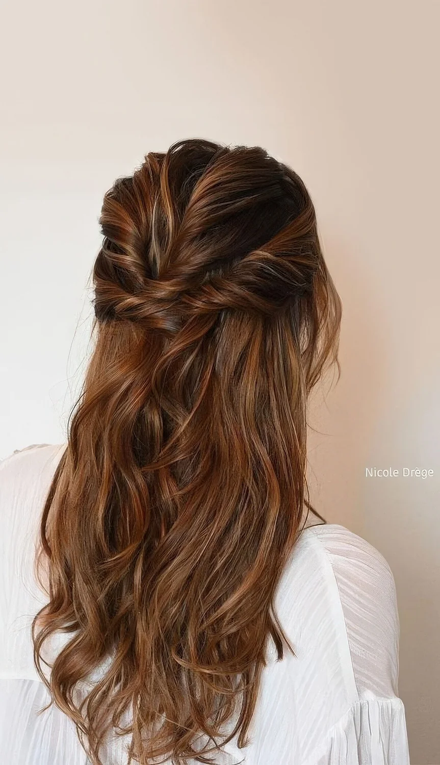 Long half updo with twists on top and sides and waves down.