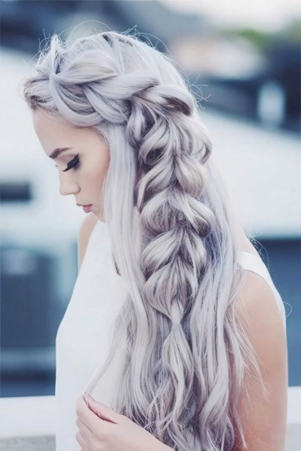 Long wavy hair down with a large side fishtail braid.