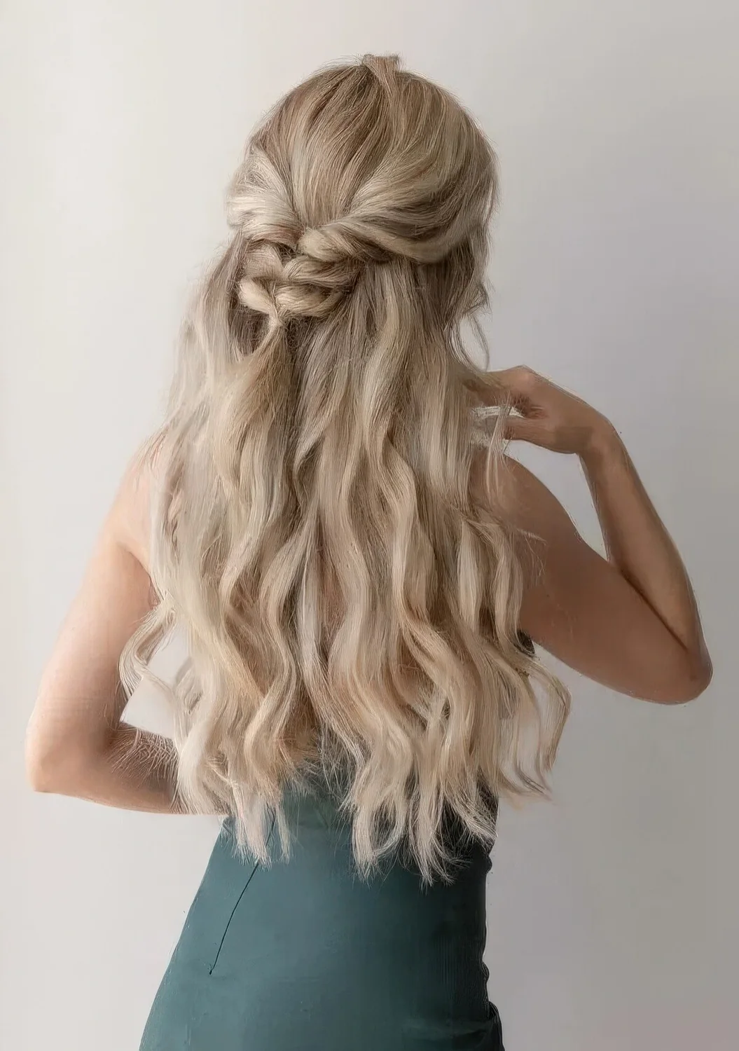 Half updo with a wavy top, a braided touch and waves down.