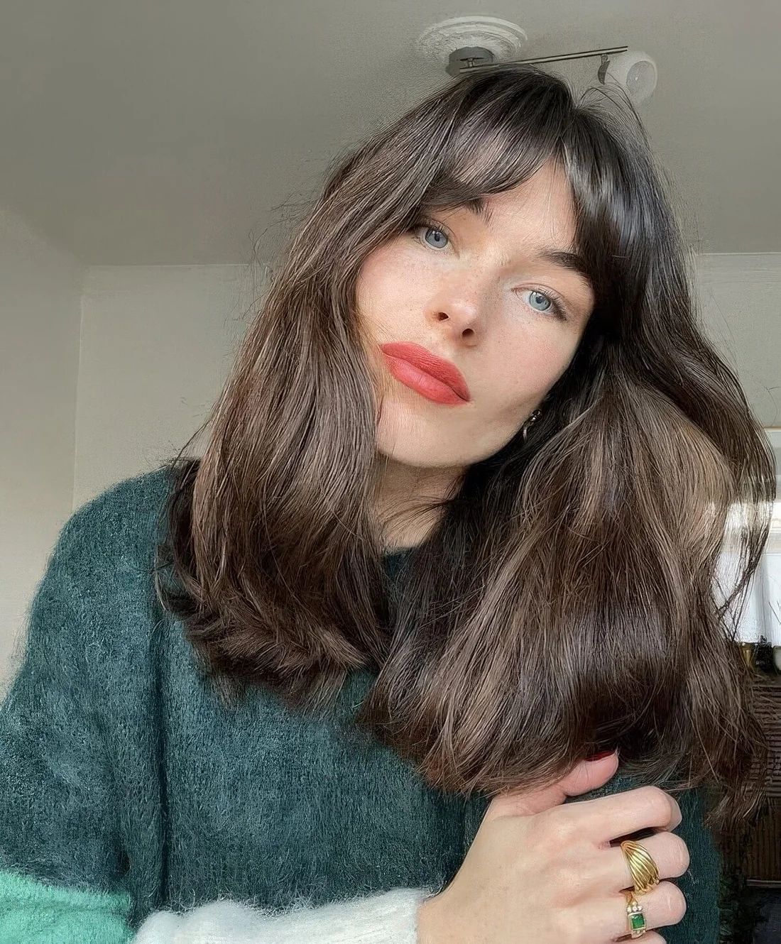 Long dark brunette hair with bottleneck bangs and a shiny touch.