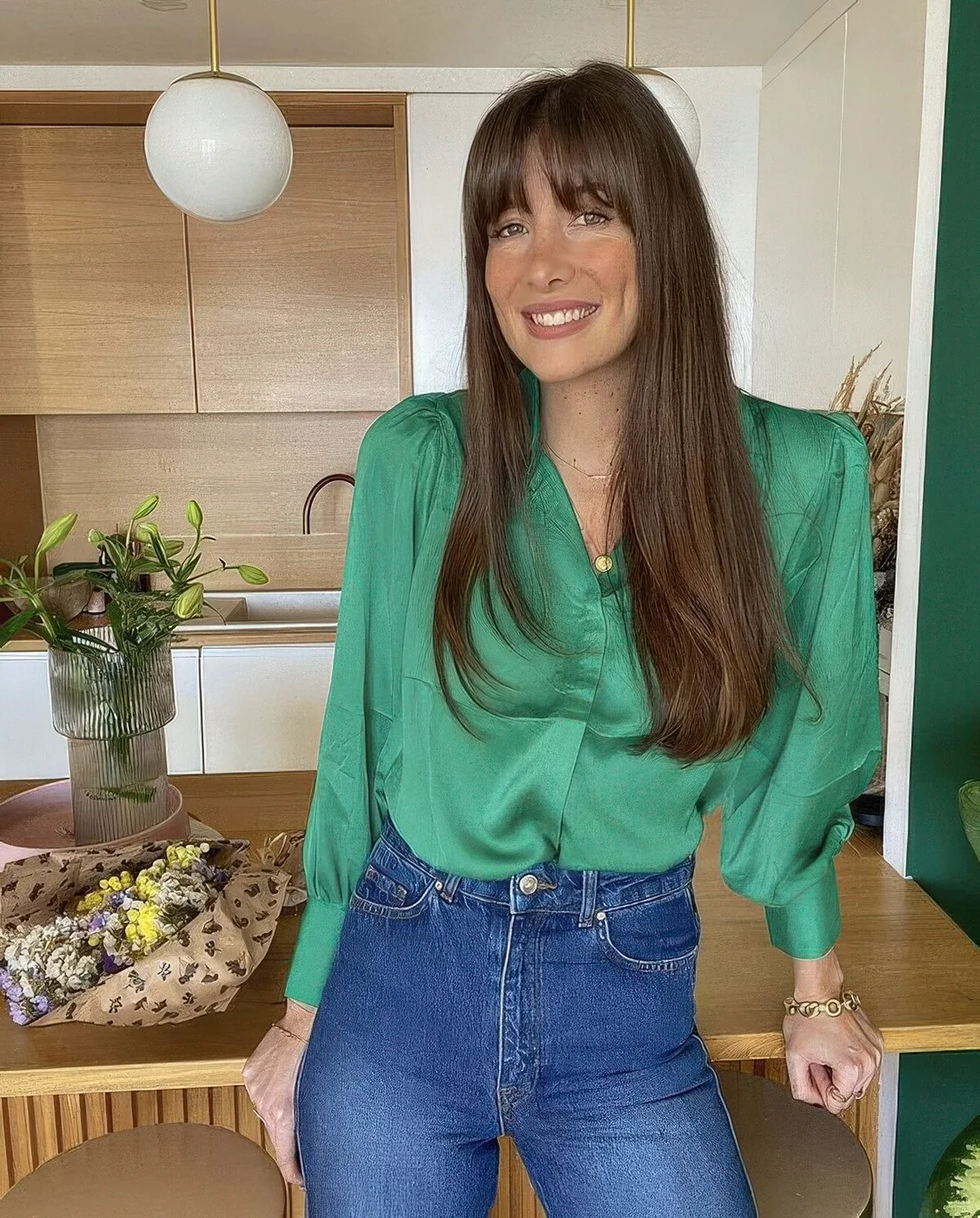 Long dark brunette hair with bottleneck bangs and curved ends.