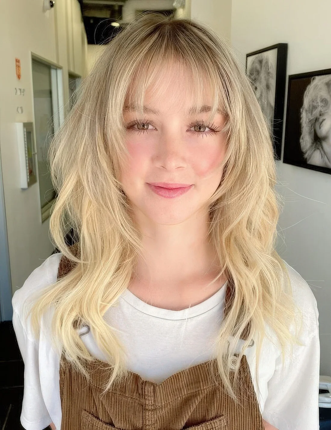 Octopus haircut in creamy blonde and with wispy bangs.