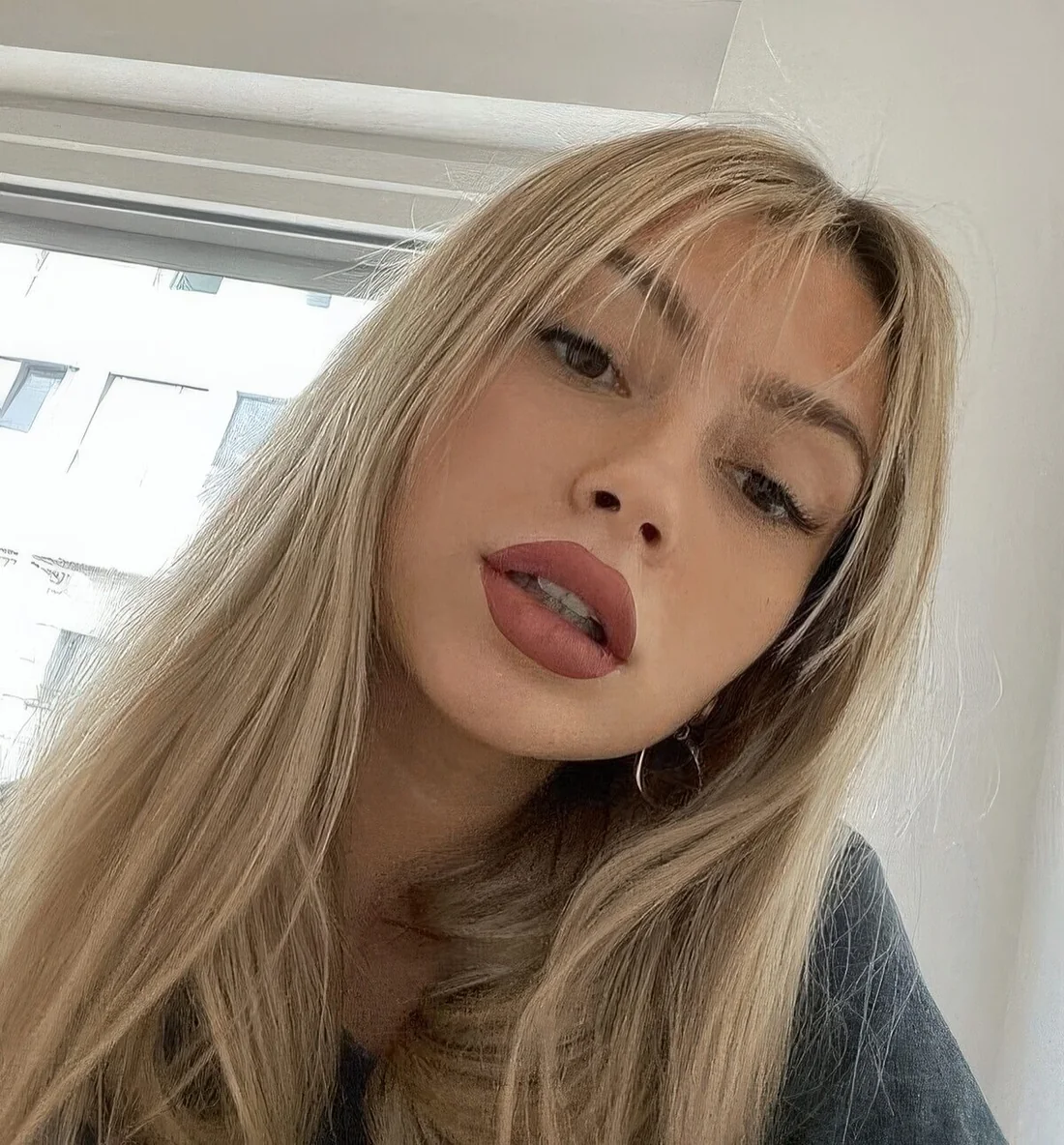 Long blonde hair with very delicate and subtle wispy bangs.