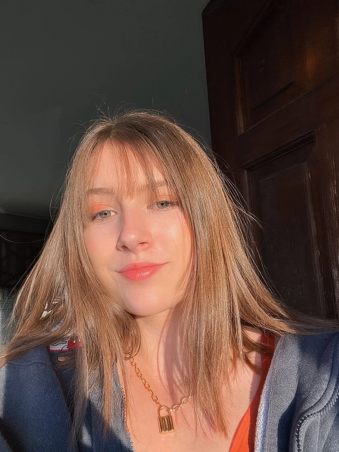Photo showing long bronde hair with wispy bangs, with the hairstyle clearly visible.